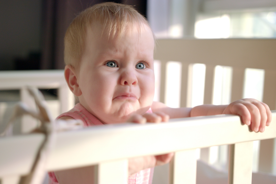 Baby waking hourly in the night crying in cot.