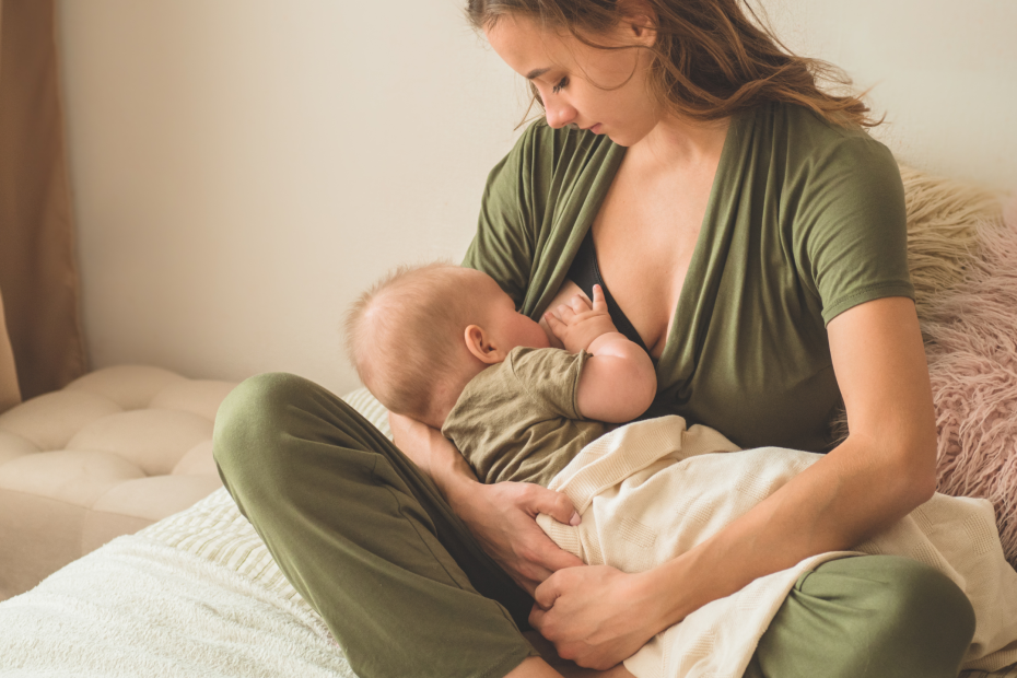 Baby and mum on bed at night having a breastfeed and feeding to sleep when mum would prefer to stop feeding to sleep