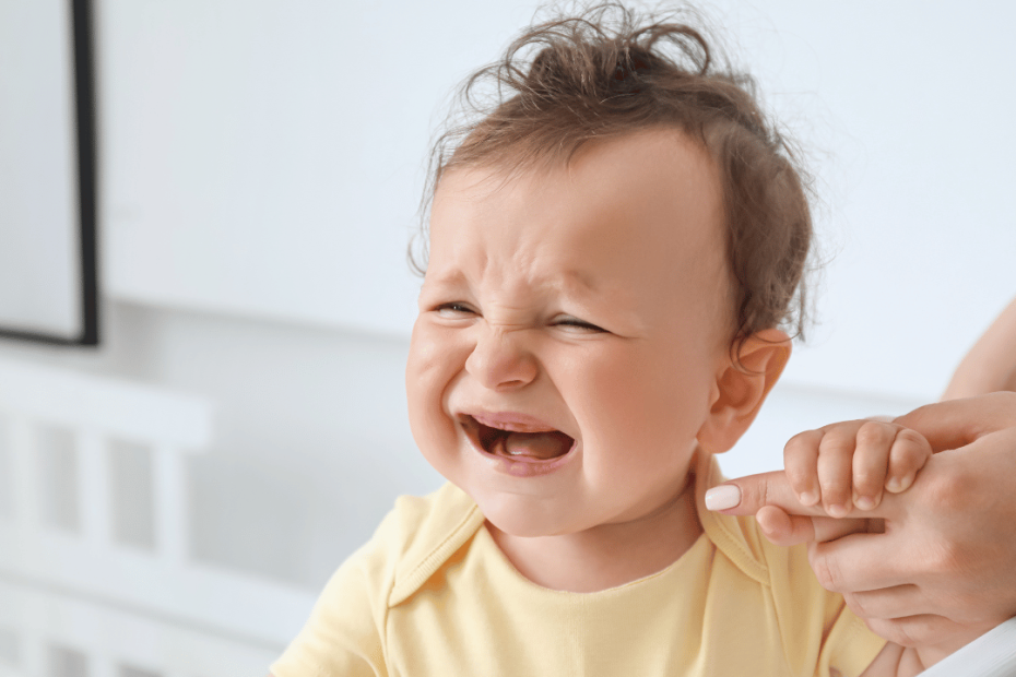 baby crying sitting in cot