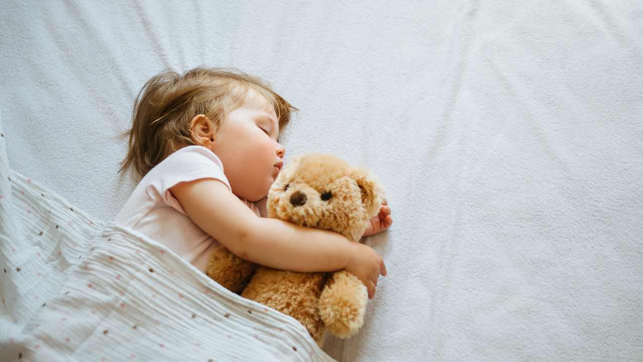 child sleeping with comforter