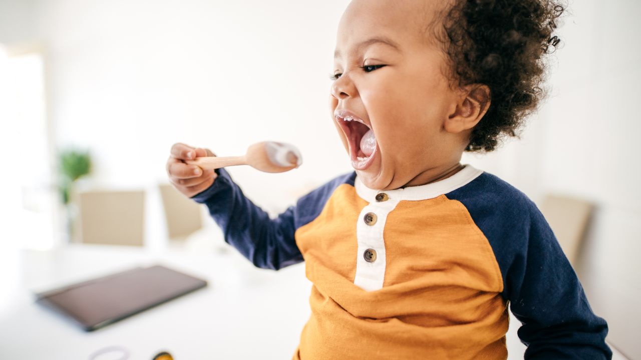 fomo baby licking a spoon