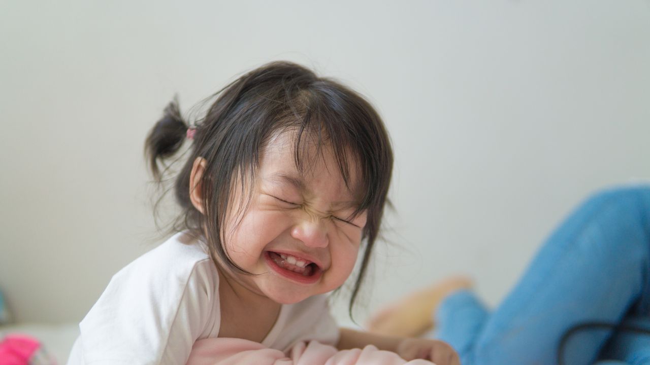 toddler grinning and very excited before going to bed